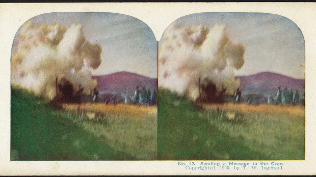 an old photograph of a very far away war in a field with white smoke rising around hills