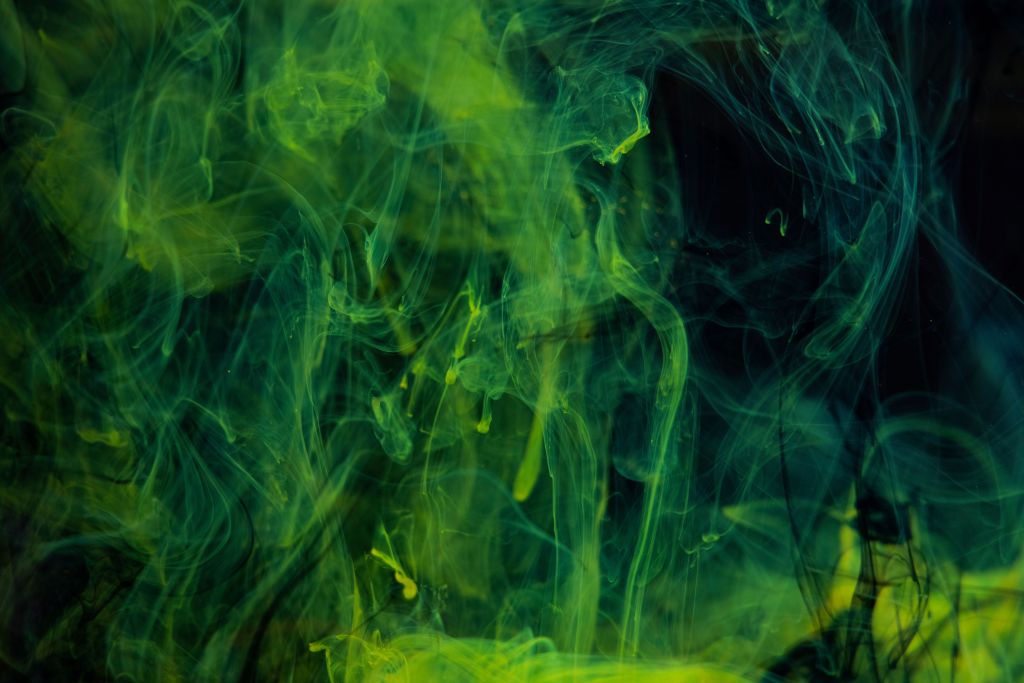 a mass of stylized green smoke on a dark background
